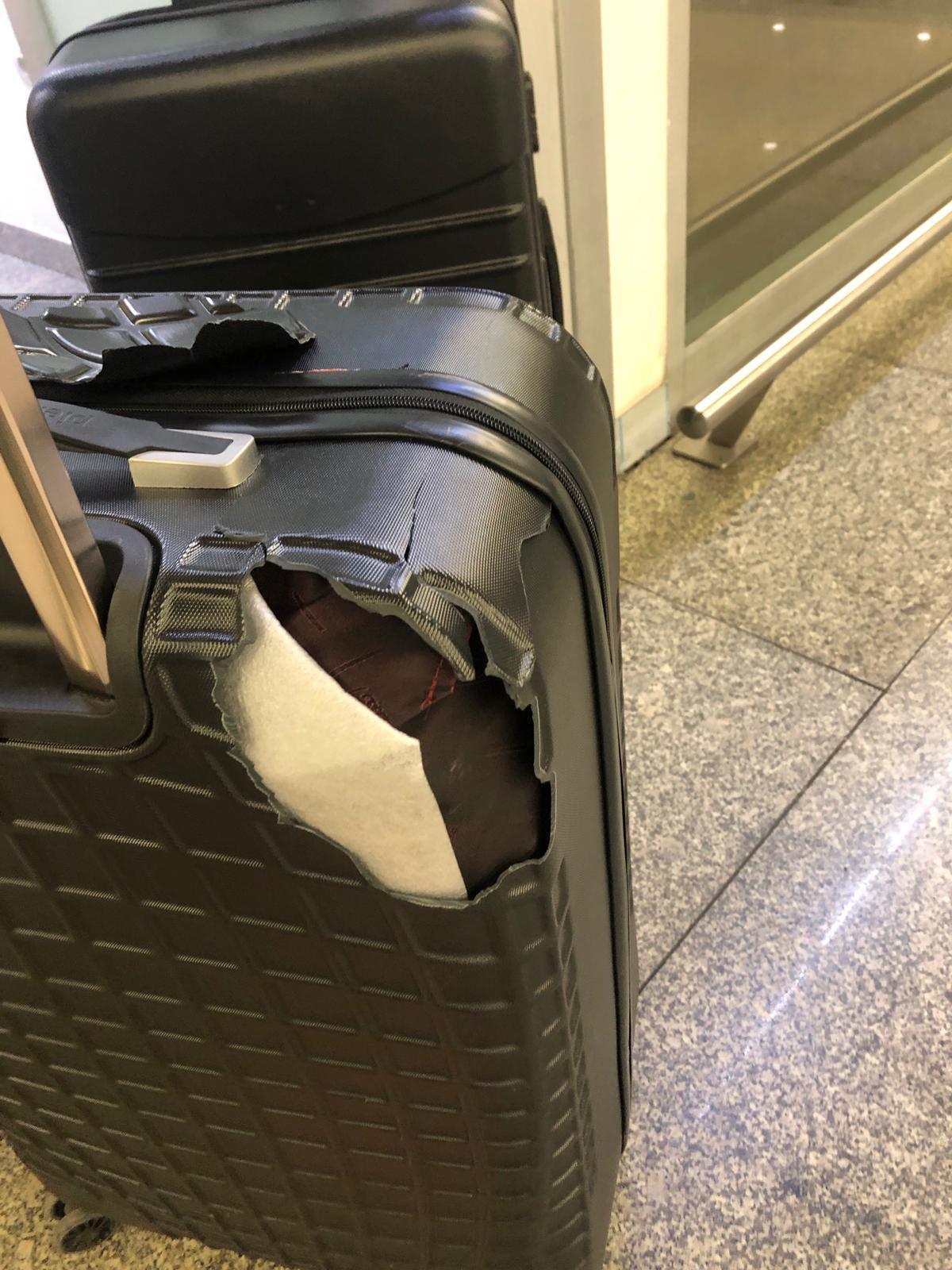 A Woman Demonstrates a Broken Suitcase on a White Background. Damaged  Baggage during the Flight. Stock Photo - Image of suitcase, plastic:  233577928