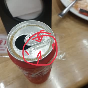 A Glass Shard Emerged from Coca-Cola Can