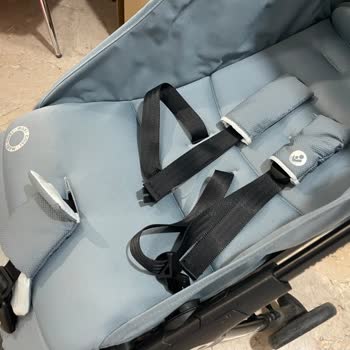 Maxi-Cosi Baby Stroller Folded Twice with Baby Inside