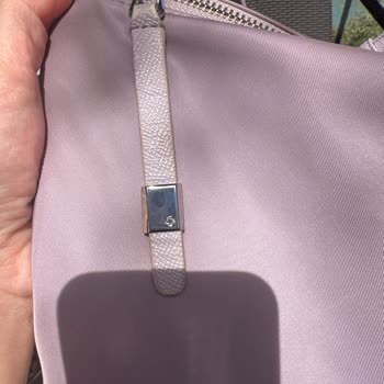 Abblätterung des Materials an Samsonite-Umhängetasche nach kurzer Nutzung