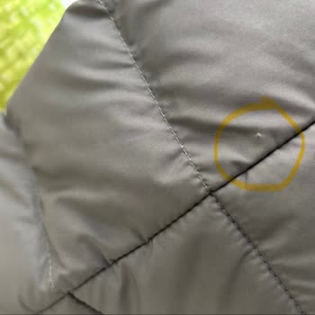 $285 North Face Jacket Shows Stitching, Stain, and Quality Defects