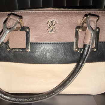 I have had this bag for about 10 years but rarely used. It was stored properly in a dark place wrapped but still the vinyl has started to peel. What a dissapointment, never buy vinyl again at least at the price point of a Guess branded bag. 