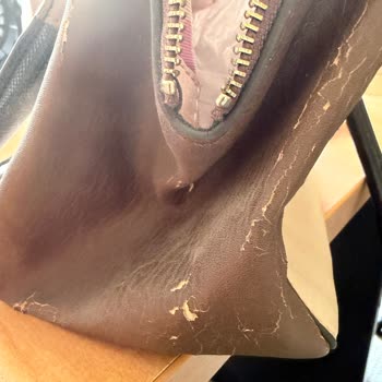 I have had this bag for about 10 years but rarely used. It was stored properly in a dark place wrapped but still the vinyl has started to peel. What a dissapointment, never buy vinyl again at least at the price point of a Guess branded bag. 